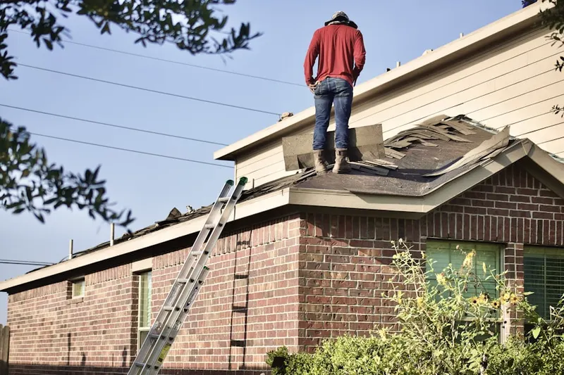 Professional roofer working on a residential roof in Woodsdale